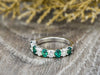 Ivy 1.5 Ct Oval Cut Moissanite and Green Emerald Half Eternity Wedding Band