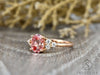 Peach champagne oval cut sapphire with diamond cluster engagement ring side view