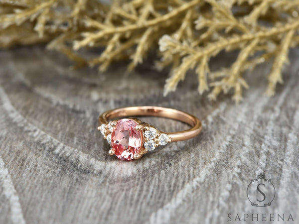 Peach champagne oval cut sapphire with diamond cluster engagement ring side view
